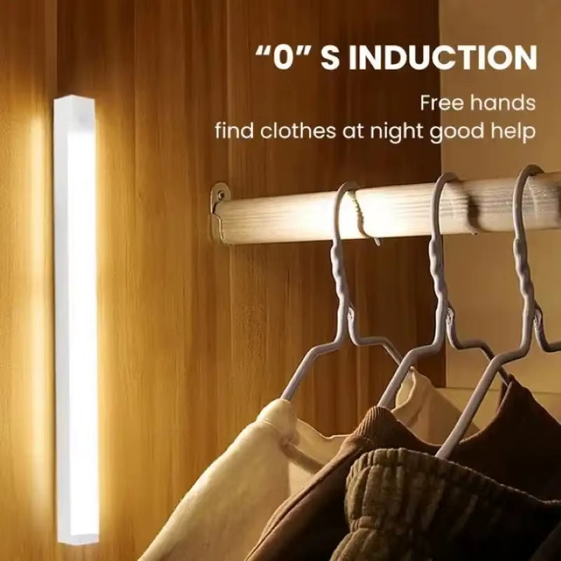 Motion sensor LED cabinet light with 0.5 second induction speed, installed inside a wardrobe with clothes hanging