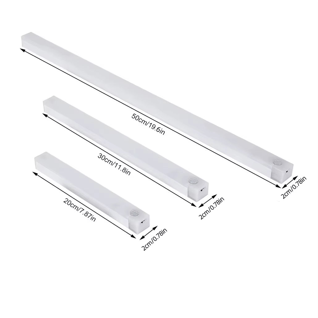 Three sizes of white LED cabinet lights laid side by side showing length differences