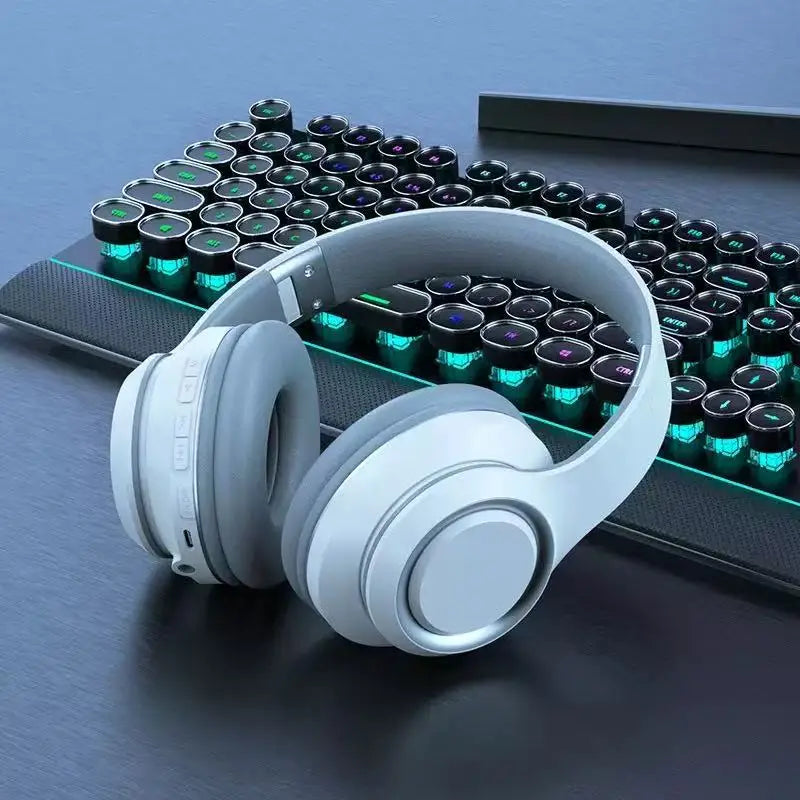 AKZ Max600 black wireless headphones on gaming keyboard right angle view