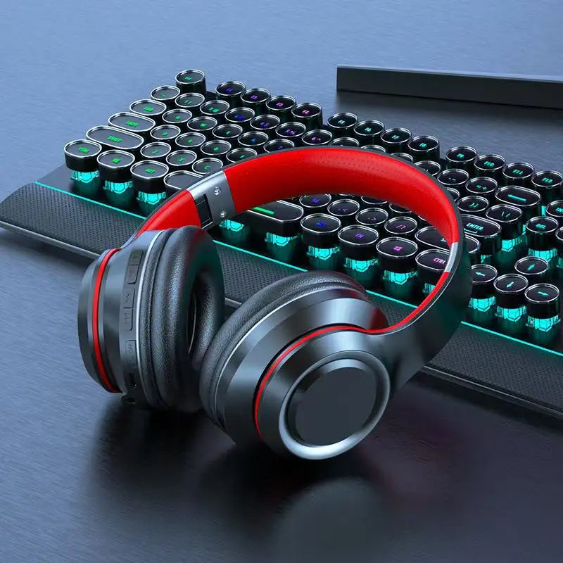 AKZ Max600 wireless Bluetooth headphones in black and red on a gaming keyboard