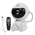 Astronaut LED star galaxy projector night light casting colourful starry sky on bedroom ceiling
