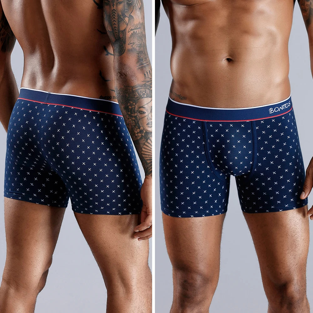 Front view of a man wearing navy blue BONAS boxer briefs with a dotted pattern, showing fit and waistband design.