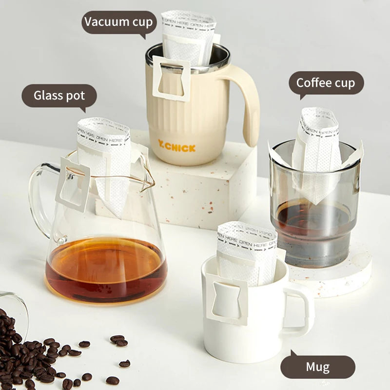 Drip coffee filter bag hanging over a glass cup with brewed coffee