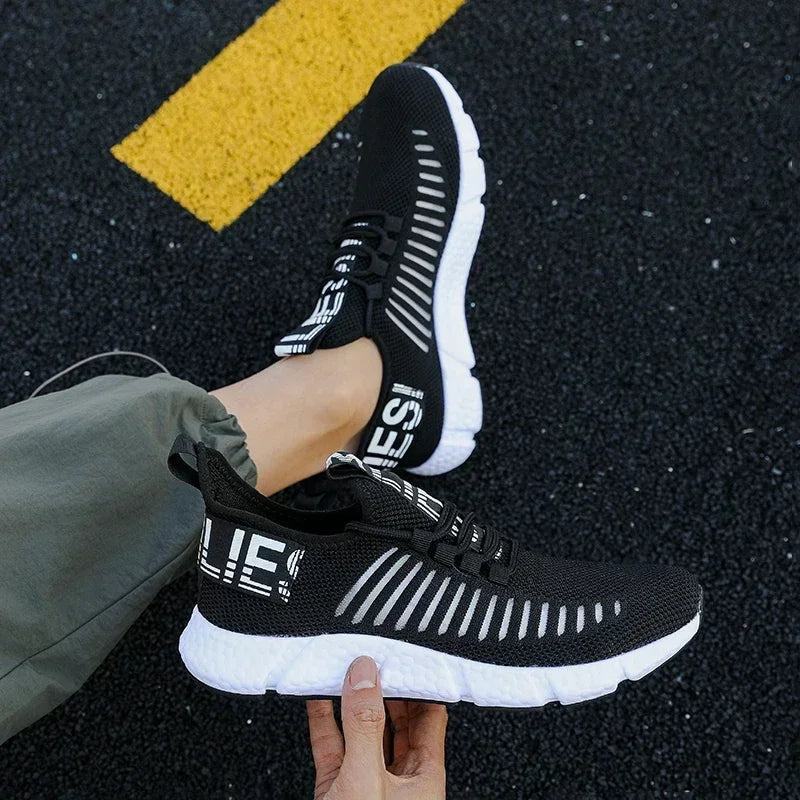 Men's black tennis sneakers worn view – flexible grip outsole on court