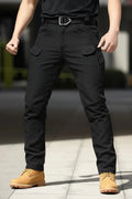 Men's black tactical cargo pants – full body lifestyle shot showing fit and style with elastic waistband